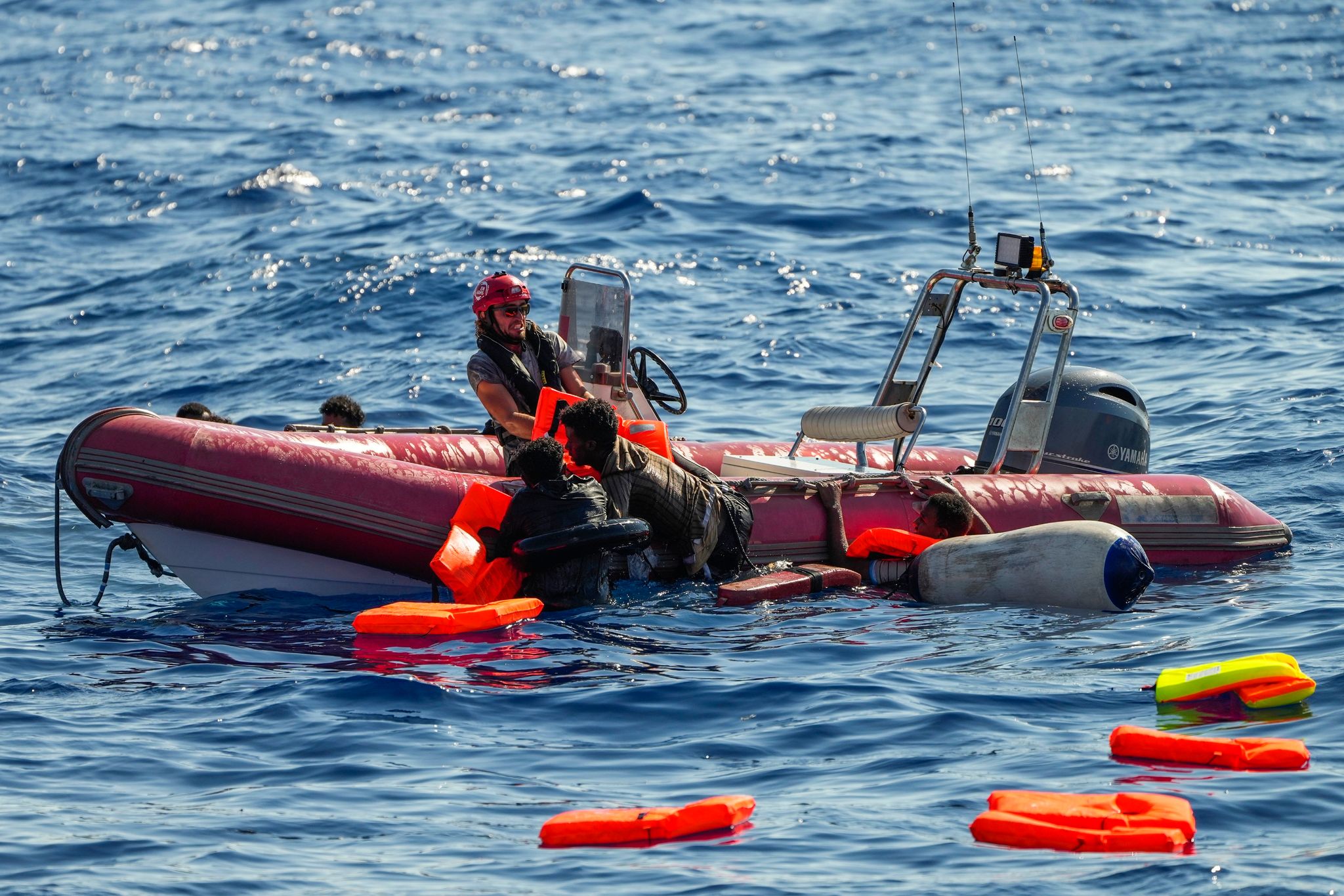Ein Mitglied der spanischen Nichtregierungsorganisation Open Arms rettet geflüchtete Menschen aus dem Mittelmeer, nachdem ihr Holzboot südlich der italienischen Insel Lampedusa gekentert ist.